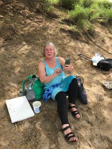 Karen painting at the beach