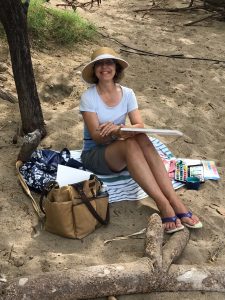 Laura painting at the beach